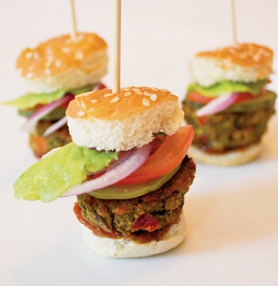 Mini lentil-and-bulgur burgers served on sesame-seed buns with curry ketchup and McClure’s pickles, by Naturally Delicious Caterers & Events in Brooklyn