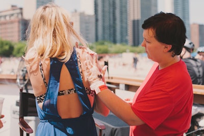 In July, Thrillist hosted the two-day Thrillist Hotel activation in Chicago. Geared toward entertaining clients, sweepstakes winners, and other V.I.P. types, the event included a Saturday afternoon 'Beachside Bash.' At the beach party, Body Art by Allison provided airbrush tattoos of symbols including margarita glasses, butterflies, and Thrillist's logo.