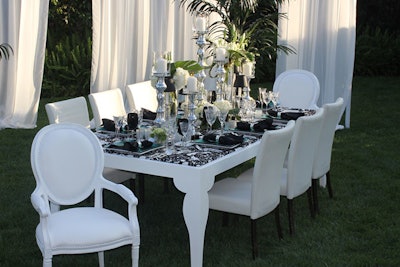 The Cielo Blanco four- by eight-foot dining table is available with custom fabric insets from Town and Country Event Rentals.