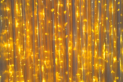 Dazian has new LED curtains available for rental or purchase. The strands of lights are hung by drape ties. They can be used on their own, layered between sheer curtains, or layered between a sheer curtain and a reflective or matte backing. The strands can also be wrapped around a column or used to create a canopy.