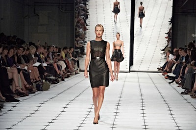 Jason Wu's runway juxtaposed the provocative, Helmut Newton-influenced designs he presented at the St. John's Center on September 7. The massive mirrored backdrop not only provided a stunning effect as models walked, but hinted at the raw sexuality of Newton's work, which was counterbalanced by the painted white squared floor's dose of feminine flair.