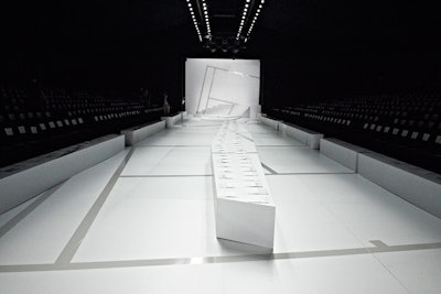 After creating a snowy scene for its February show, Lacoste went simple and stark for its spring runway setup on September 8 at the Lincoln Center tents. Produced by Bureau Betak, the clean, all-white backdrop inspired by the London Zoo's penguin pool complemented the first 13 all-white looks that then evolved to introduce color into the mix.
