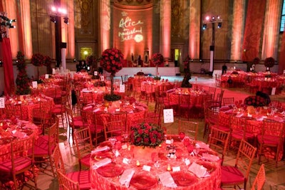 Inside the auditorium, red linens, chairs, cushions, place settings, and rose-tree-style centerpieces filled the space in a re-creation of the Queen of Hearts' palace. A wash of red lighting from Digital Lightning completed the look.