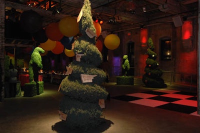 Cossette Communications in Toronto paid tribute to Alice in Wonderland with their 2007 holiday party featuring teapots filled with flowers, topiaries, and paper roses. Wooden signs hanging from one of three 12-foot juniper trees pointed guests in the right direction.