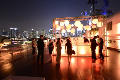 Groups of white lounge furniture provided seating outdoors, and glowing lanterns made the central bar easy to spot from afar.