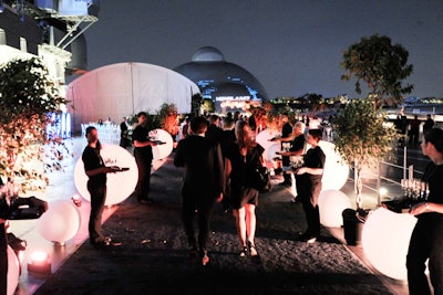 Following the screening, guests headed upstairs to the open-air flight deck, where illuminated spheres and potted trees lined the pathway to the party space.