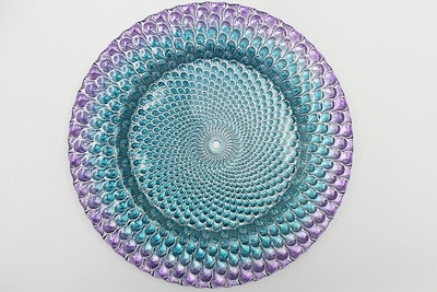 Add a splash of color to tabletops this fall with an eye-catching plate like the purple-and-turquoise Luxe charger, $8, from Atlas Party Rental.