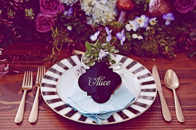 For an Alice in Wonderland-inspired design inspiration shoot, Kate Miller Events displayed Luxecuts custom laser-cut place cards leaning against vintage teacups filled with flowers at each place setting.