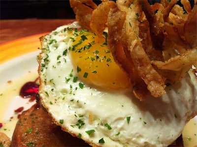 Delicioso Catering DC is bringing a traditional breakfast dish to the dinner table this fall with their new steak-and-eggs plate. A pan-seared potato is topped with a six-ounce filet, a sunny-side-up egg, and lightly fried onion rings.