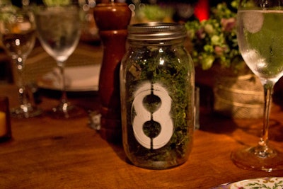 Moss-filled mason jars served as table numbers.