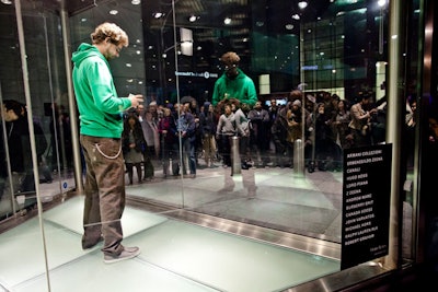 At 'Re-', performers solved a Rubik's cube over and over inside a Harry Rosen display case. Microphones attached to their sleeves amplified the sounds of the shifting cube, and the audience outside cheered them on.