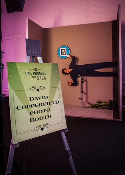 To play up David Copperfield's involvement in the evening, the planners behind the L.A.'s Promise gala worked with the magician's team to set up a photo booth that would create the illusion of guests floating in the air. At first glance, the set-up looked odd, with a plant and Copperfield cut-out placed sideways against a wall.