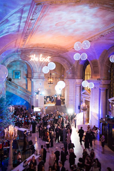 Clear fishing wire holding more than 1,300 hand-painted feather butterflies and balloons extended from the tree branches up to the ceiling of Astor Hall.