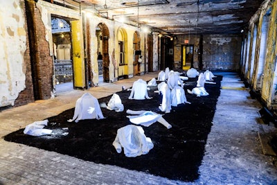 '(E)motion field,' video installation artist Frédérique Chauveaux's 10- by 32-foot piece, consisted of nearly four dozen Margiela white shirts molded into different shapes, arranged on a soil-covered floor and projected with images.