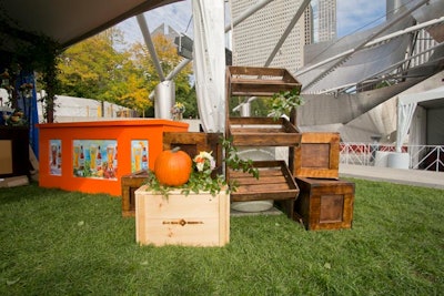 For Blue Moon's autumnal tent, designers brought in dark-stained wood pergolas and clusters of mason jars filled with mixed floral arrangements that complemented the brand's trademark orange-and-yellow color palette. 'To bring more of a harvest look to the space, I did a bright orange bar, which was the perfect pop for the brand,' said Wagner.