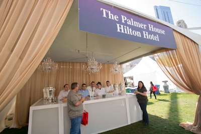 The Palmer House Hilton Hotel set up a tent to offer tastings from its Lockwood Restaurant and Potter's Lounge. To channel the venue's meld of old-world aesthetics and modern amenities, Event Creative designers filled the tent with plexiglass bars and crystal chandeliers.
