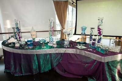 Linens and flowers in the Air room were a combination of teals, blues and purples, all with an icy, metallic sheen to perfect the look. The decor was coordinated with dramatic lighting and specialty cocktails to create a cohesive look.