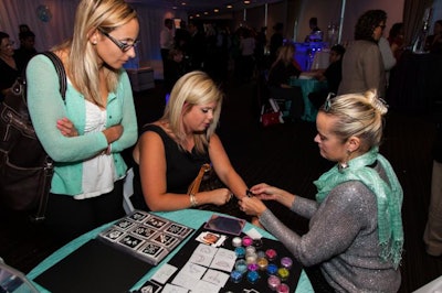 Guests found a zen state in the Water room, where they were pampered with massage stations, manicures, and glitter tattoos, pictured here.