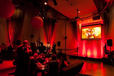 The Fire room was bathed in dramatic red light. Red centerpieces, hovering balloons and red furniture and drape gave the large space an intimate feel.