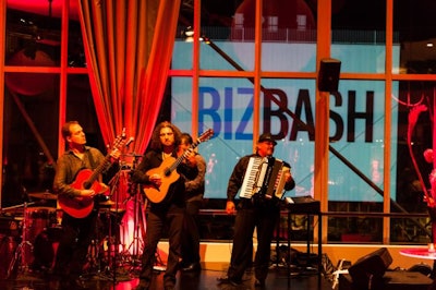 Entertainers performed on a stage in the Fire room surrounded by windows. The BizBash logo is displayed on a 72' by 32' outdoor, high-definition projection screen, perfect for branding any event.