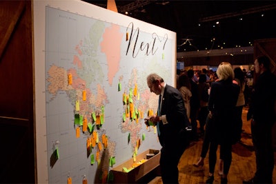 Inside the entrance to the Travel & Leisure Global Bazaar at the 69th Regiment Armory, a large map asking the question, 'Next?' invited guests to write their names on a neon-colored piece of paper and pin it to their future destinations.
