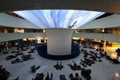 Visitors lay on the floor of City Hall to watch 'Civilization (Megaplex).' Projected on to the curved pillar of the rotunda, images funneled down and disappeared. The video began in 'hell' and panned up to 'heaven.'