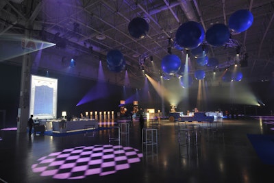 In the main event space, blue balls hung from the ceiling and checkerboard-patterned lights illuminated the floor. Projections of windows lined the room, and the 'Dream Machine' anchored the centre of the space.