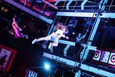 A total of 21 performers (seven aerialists, four dancers on the ground, two aerial drummers, four drummers on the ground, and four performing riggers that were visible and part of the act), all clad in clothing from the Target fall style campaign, entertained the crowd of 400 guests with a series of rapid-fire, high-energy aerial performances.