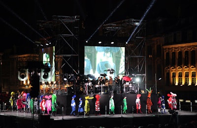 A massive, four-sided stage housed a mist-shrouded fashion show for designer Jean-Charles de Catelbajac. DJ Mr Nô spun, and models appeared on giant screens overlooking the city square. Along with bright, avant-garde clothing, models wore headpieces that resembled everything from yellow mouse ears to green skulls; some wore Day of the Dead-style makeup.