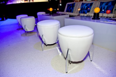 The all-white lounge furniture included rocket ship-inspired ottomans.