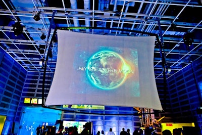 Screens surrounding the reception area displayed a loop of sponsor logos and event information.