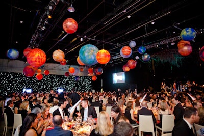 Dinner was served in the Exhibition Hall of the Ontario Science Centre, where planets hung overhead and a wall of LED lights mimicked a starry sky. The first annual Innovator's Awards were presented on stage.