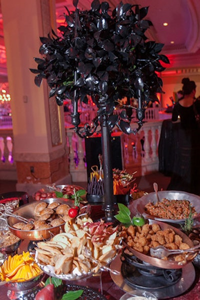 Occasions set up three food stations on the second floor serving savory items like salmon tartare, short rib sliders, Dracula fang-shaped crudites, roasted red potatoes, and boneless chicken bites.