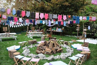 Pieces from the clothing collection hung above a kitschy campfire set up on the lawn.
