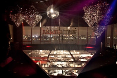 At Le Bain, the silver Mylar chandeliers matched the disco balls that filled the pool. A plexiglass pane covered the pool, creating a stage for the night's performer.