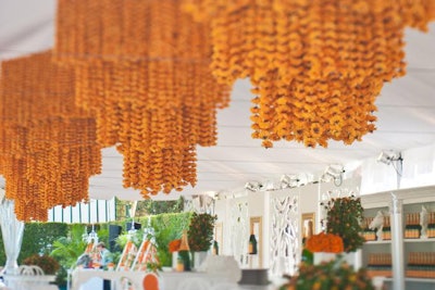 At the Veuve Clicquot Polo Classic, a collection of six marigold chandeliers filled the V.I.P. tent ceiling, each standing eight feet high and made from thousands of strands of silk marigolds in the brand's recognizable yellow shade.