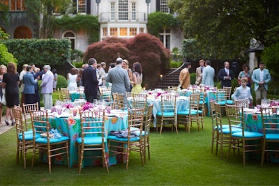 For a springtime luncheon on the lawn of Rollins' home, rounds were covered in vibrant chinoiserie tablecloths. 'Centerpieces of goldfish in bowls, a nod to my inner Auntie Mame, were set atop bright orange lacquered plant stands,' writes Rollins. Silver julep cups holding pink peonies surrounded the bowls. 'Napkins with colorful, embroidered floral letter Rs, bamboo-handled flatware, amethyst-colored water glasses, and aqua-bordered tented name cards written in a beautiful calligraphic hand in yellow ink tied the look together.'