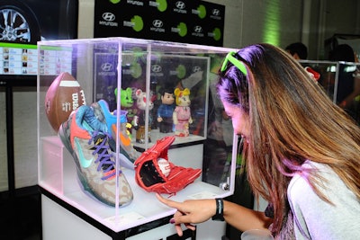 In addition to the cars, the 'Re:Mix Lab' also displays other products, including sequined sneakers and Kid Robot figurines.