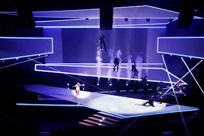 Designed by Star Theodos Kahn and built by Atomic Design, the striking set for the presentation in the Rose Theater had a clean, linear look. This gave producers an uncluttered backdrop for the various stunts that took place on stage. The opening sequence saw Gretchen Colon, Turner Broadcasting Latin America's senior vice president of ad sales, attacked by motorcyclists, who were thwarted by a S.W.A.T. team, football squad, and other action movie-style characters.