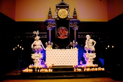 Beside a DJ station, living statues sat atop pedestals surrounded by candles.