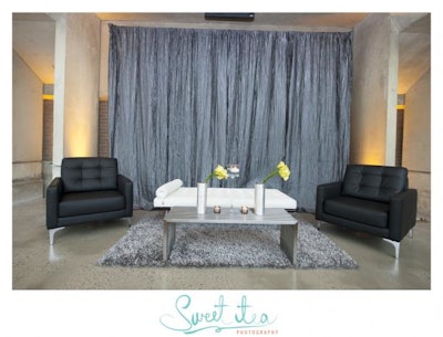 Guests entered '50 Shades of AFR' through a space inspired by Christian Grey's apartment. The austere, office-like environment featured leather furniture with clean lines in black, white, and grey.