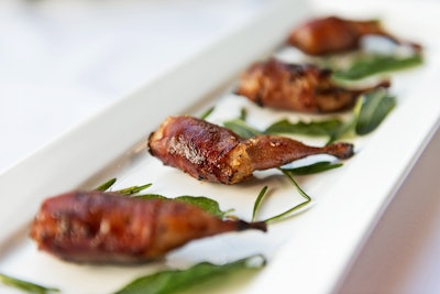 Ontario quail legs filled with Berkshire sausage and wrapped with Niagara prosciutto, by 10tation Event Catering in Toronto