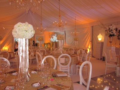 Some 50 guests gathered at a private home in Forest Hill for one of the largest of the Grand Cru dinner parties. Inspired by Louis XIV and Marie Antoinette, the event took place in an elegant tent that took six days to build out. A plexiglass floor covered an existing swimming pool, while chandeliers and decorative lamps added a warm glow to the gold-and-white space.