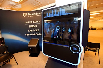 TouchTunes Interactive Network's Virtuo machine serves three functions: it's a digital jukebox, a karaoke machine, and a photo booth that prints out strips of images with a variety of backgrounds. The machine can be rented for meetings and events.