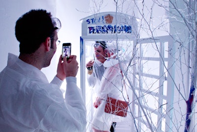 A red phone booth flown in from Canada was converted into a white photo booth that guests could decorate with paint. Inside, a digital camera taped to the wall and painted with the words 'Press Me' invited guests to snap pics of themselves. The photos were sent to a laptop onsite and could later be viewed on UrbanDaddy's Web site.