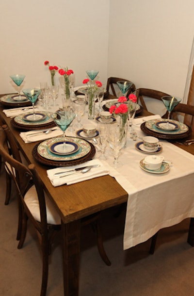 The display from Hall's Rental had vintage-inspired plates, a farm-style table, and French Country chairs.