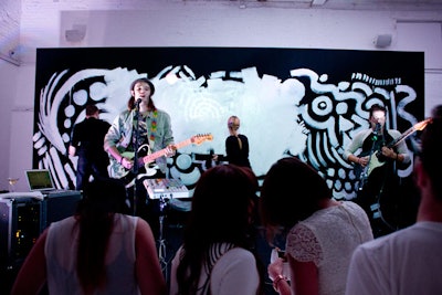 The night's live entertainment also included some interactive art, with the band Cherub performing while artists painted the black backdrop with white, glittery paint.