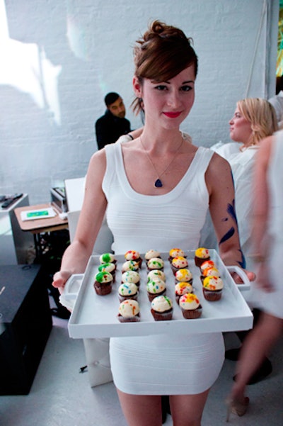 To match the decor toward the end of the event, servers passed brightly colored desserts, including red velvet cupcakes topped with multicolored icing.