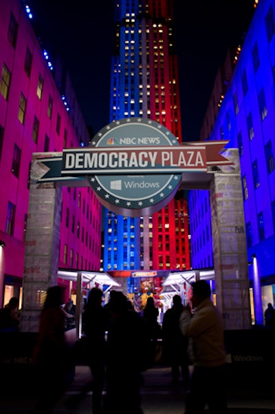 The Fifth Avenue entrance to Rockefeller Plaza was marked with branded signage, and surrounding buildings were awash with red and blue lighting.