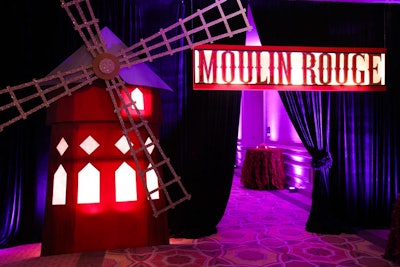 André Wells created an entryway to the event space reminiscent of the Moulin Rouge's signature windmill and red signage.
